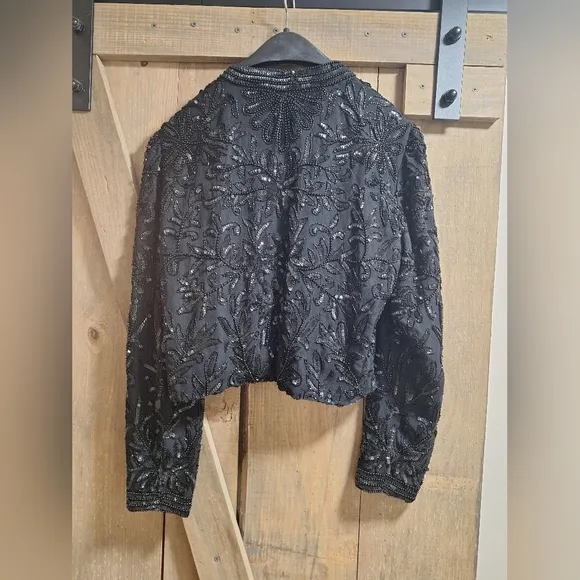 A Niteline by Della Roufogali 100 silk lined embellished blazer in a size small.