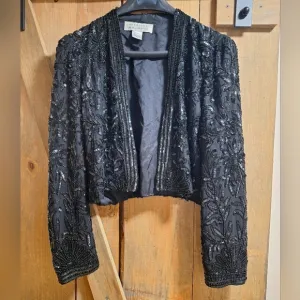 A Niteline by Della Roufogali 100 silk lined embellished blazer in a size small.